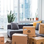 Bright city apartment interior with boxes shows moving day setup.